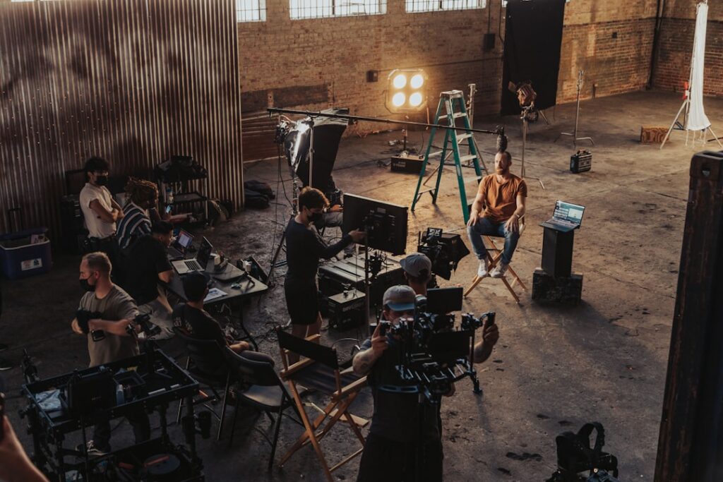 Film crew working around a cinema camera on set