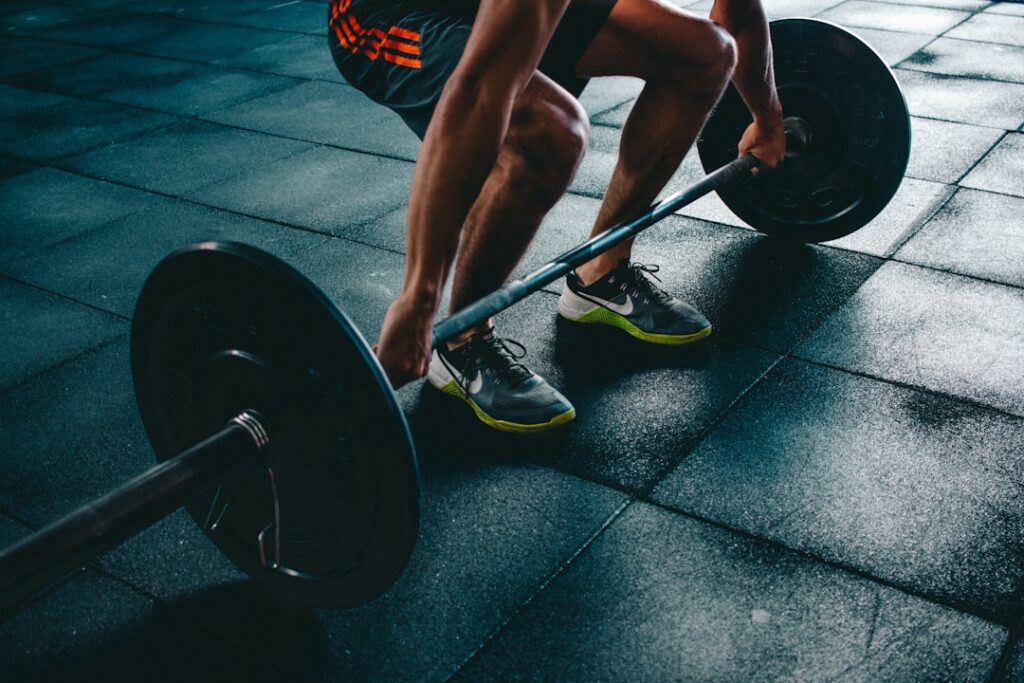 Athlete preparing for a barbell lift during hybrid training
