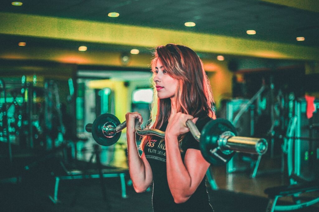 Female athlete lifting a barbell during strength training